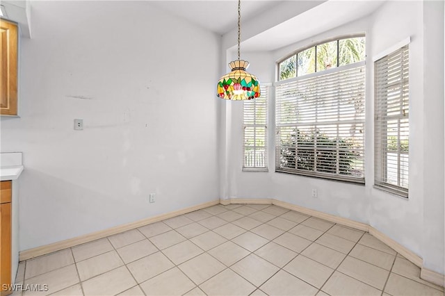 unfurnished dining area featuring light tile patterned floors