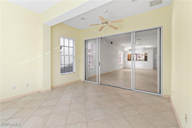 unfurnished bedroom with ceiling fan, light tile patterned floors, and a closet