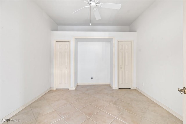 interior space with ceiling fan and light tile patterned flooring