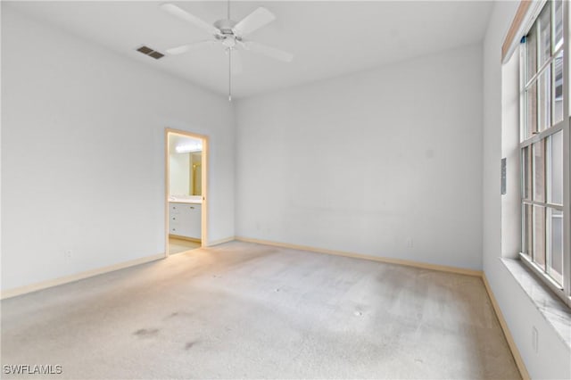 empty room with light carpet, ceiling fan, and a healthy amount of sunlight