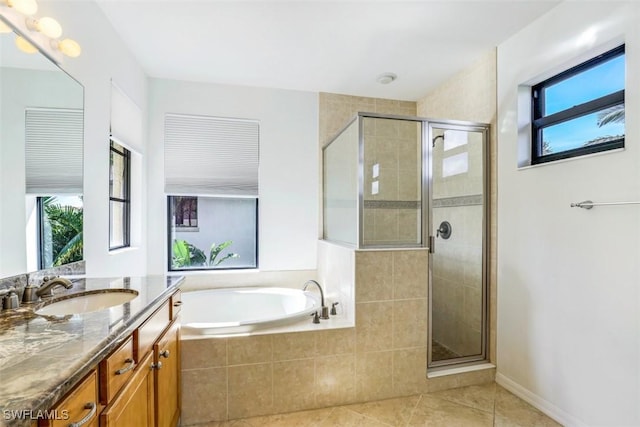 bathroom with tile patterned flooring, vanity, and plus walk in shower