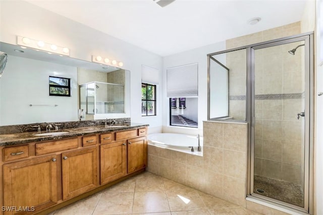 bathroom featuring tile patterned floors, vanity, and shower with separate bathtub