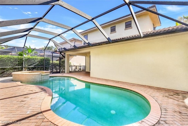 view of pool featuring an in ground hot tub, a patio, and a lanai