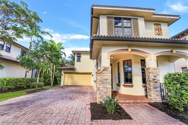 mediterranean / spanish-style house with a garage