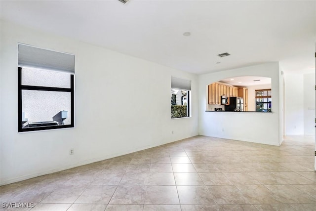 unfurnished living room with light tile patterned floors