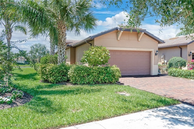 view of front of property with a front yard and a garage