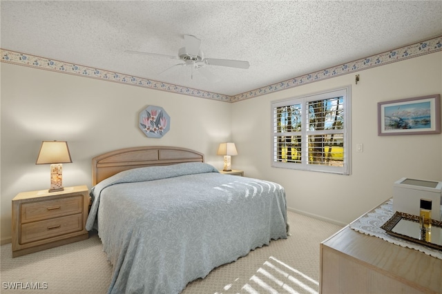 bedroom featuring ceiling fan, light carpet, and a textured ceiling