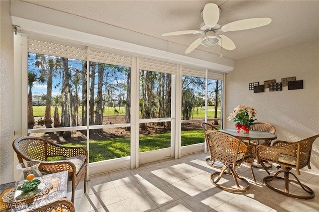 sunroom featuring ceiling fan