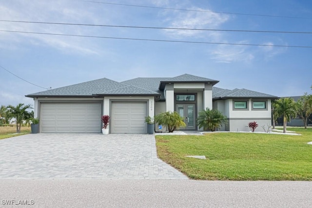 prairie-style home with a garage and a front lawn