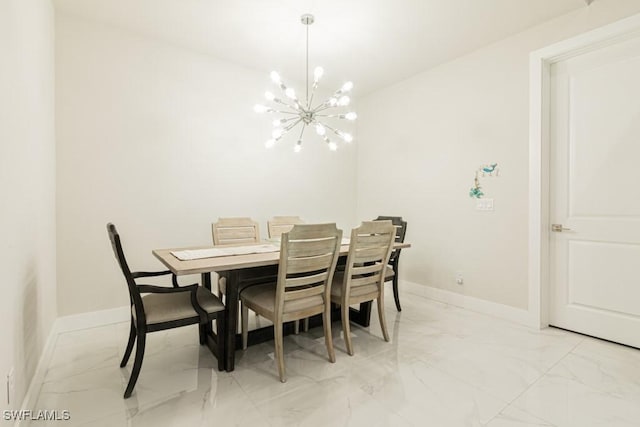 dining space featuring a chandelier, marble finish floor, and baseboards