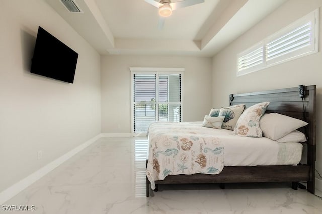 bedroom featuring baseboards, visible vents, a raised ceiling, a ceiling fan, and marble finish floor