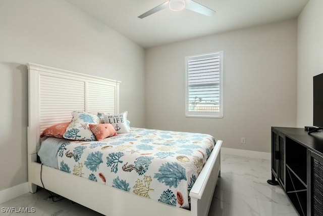 bedroom with marble finish floor, a ceiling fan, and baseboards