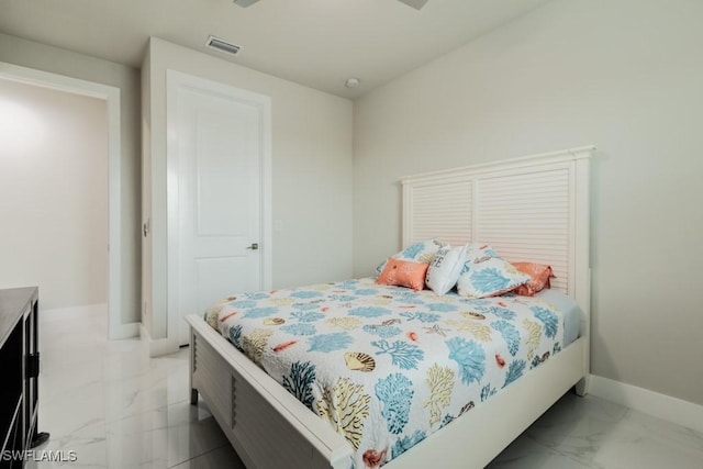 bedroom featuring marble finish floor, visible vents, and baseboards