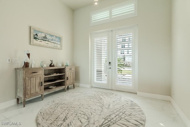 doorway with marble finish floor, french doors, and baseboards