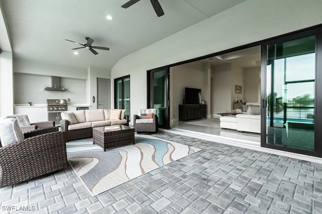 view of patio / terrace featuring ceiling fan, exterior kitchen, grilling area, and an outdoor living space