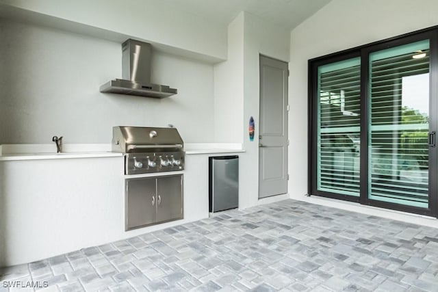 view of patio / terrace featuring a grill and an outdoor kitchen