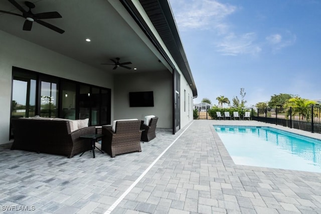 view of swimming pool with a fenced in pool, fence, outdoor lounge area, and a ceiling fan