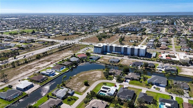 drone / aerial view with a residential view and a water view