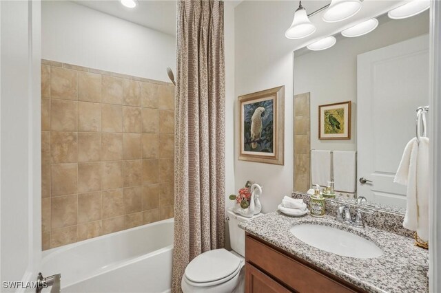 full bathroom with shower / bath combo, vanity, and toilet