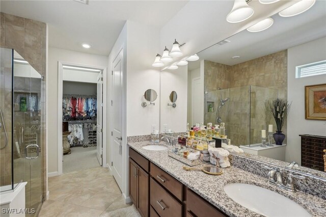 bathroom with a shower with door and vanity