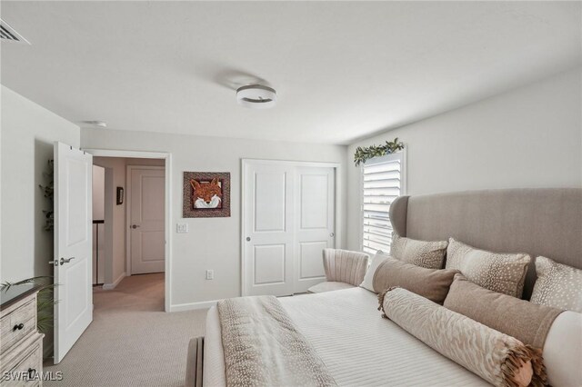 carpeted bedroom featuring a closet