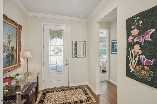 entryway with wood-type flooring and crown molding