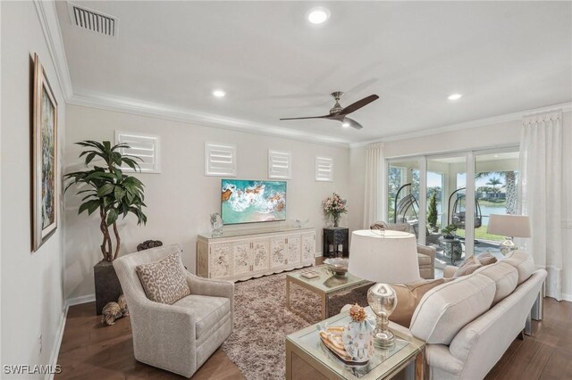 living room with crown molding, dark wood-type flooring, and ceiling fan