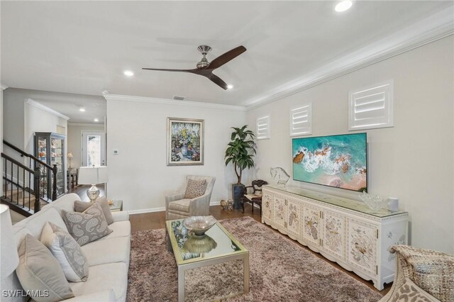 living room with crown molding, hardwood / wood-style floors, and ceiling fan