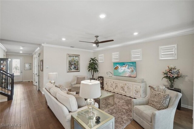 living room featuring hardwood / wood-style flooring, ceiling fan, and ornamental molding