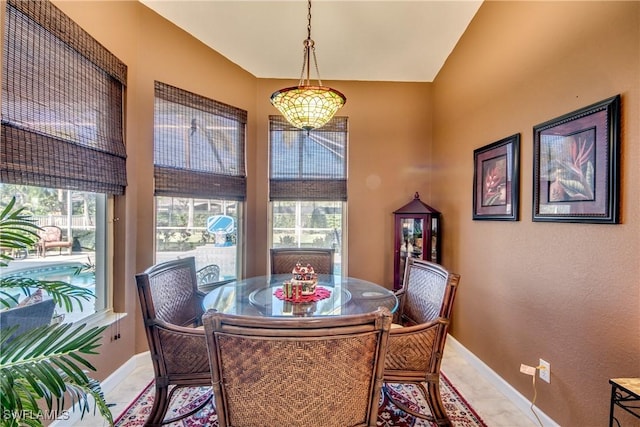 dining space with a wealth of natural light and lofted ceiling