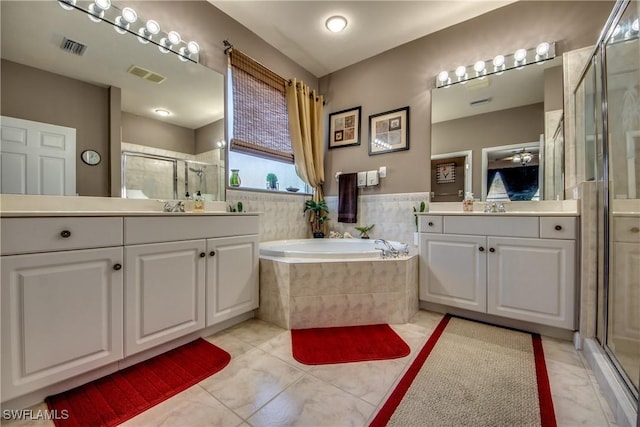 bathroom featuring vanity, tile patterned flooring, and plus walk in shower