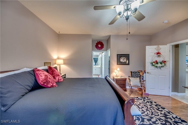 bedroom with ceiling fan, light hardwood / wood-style floors, and ensuite bathroom