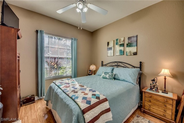 bedroom featuring light hardwood / wood-style floors and ceiling fan