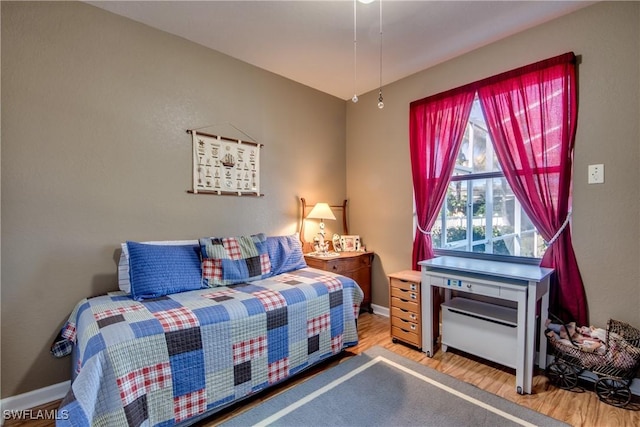 bedroom with hardwood / wood-style flooring