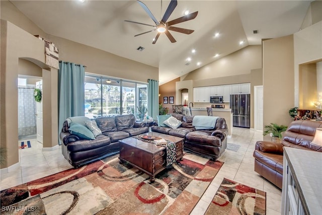 living room featuring ceiling fan, high vaulted ceiling, and light tile patterned floors