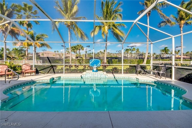 view of pool featuring glass enclosure and a patio area