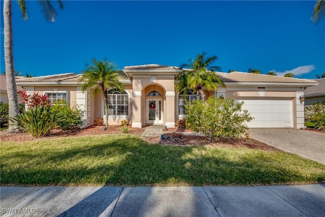 view of front of home featuring a garage and a front lawn