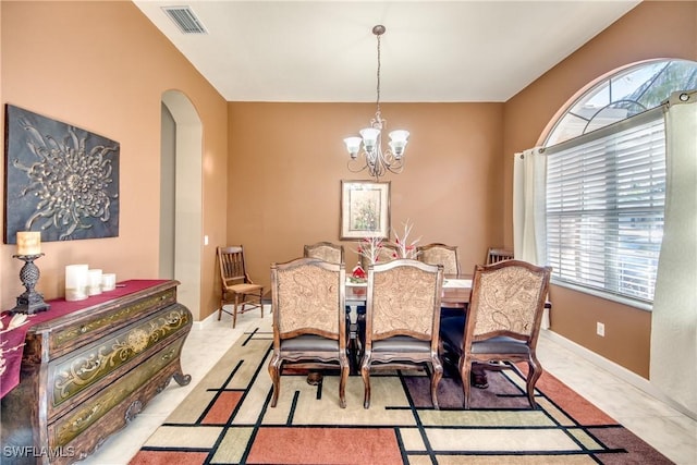 dining area with an inviting chandelier