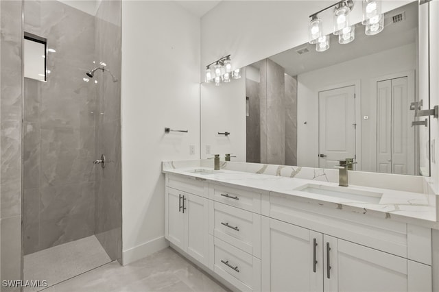 bathroom featuring a tile shower and vanity