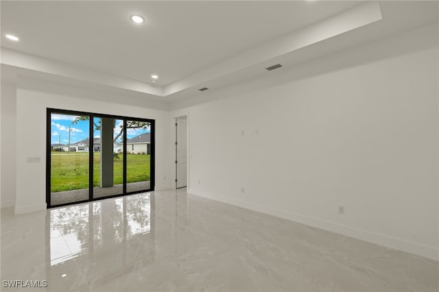 empty room featuring a tray ceiling