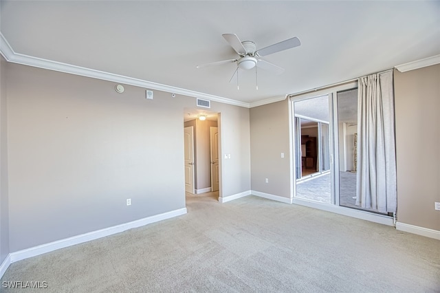 unfurnished room featuring crown molding, baseboards, ceiling fan, and visible vents