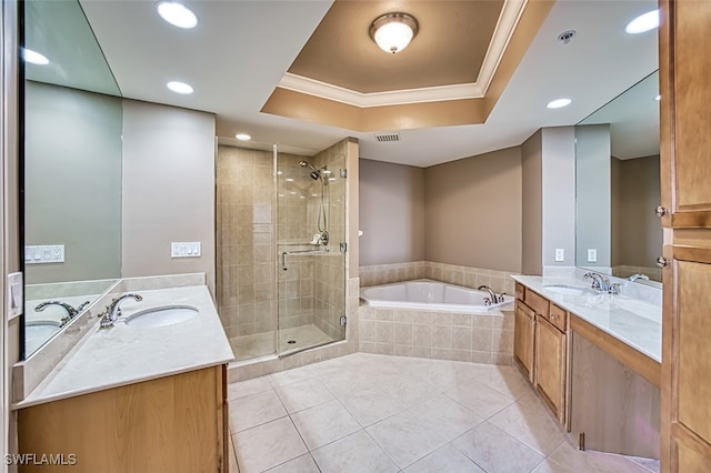 bathroom with a raised ceiling, vanity, tile patterned floors, and plus walk in shower