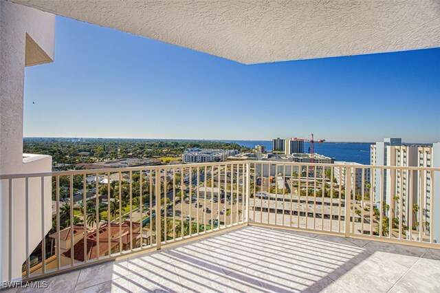 balcony featuring a city view and a water view