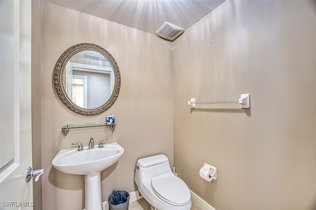 bathroom featuring toilet and sink