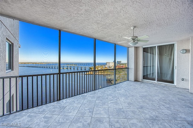 unfurnished sunroom featuring a water view