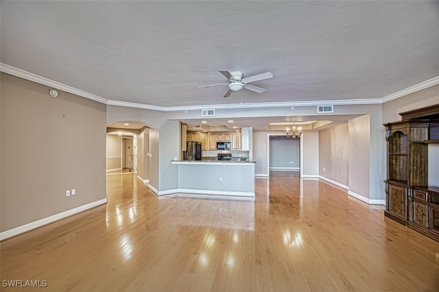 unfurnished living room with visible vents, crown molding, arched walkways, baseboards, and ceiling fan with notable chandelier