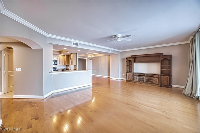 unfurnished living room featuring ceiling fan with notable chandelier, light hardwood / wood-style flooring, and crown molding