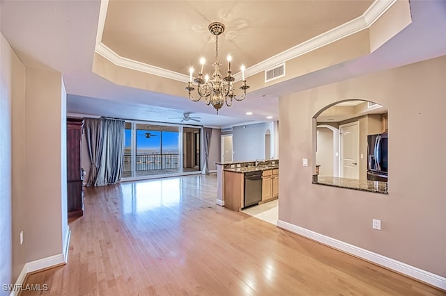 kitchen with dishwasher, ceiling fan with notable chandelier, light hardwood / wood-style flooring, a tray ceiling, and fridge with ice dispenser