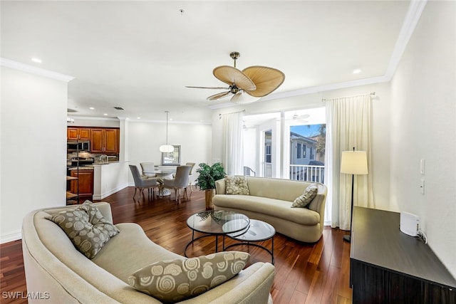 living room featuring ceiling fan, dark hardwood / wood-style flooring, and ornamental molding