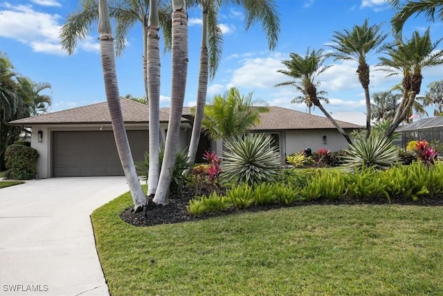 view of front of house featuring a front lawn and a garage